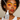 Woman with grapefruit slices on eyes holding a GLAMZ vitamin C serum bottle.